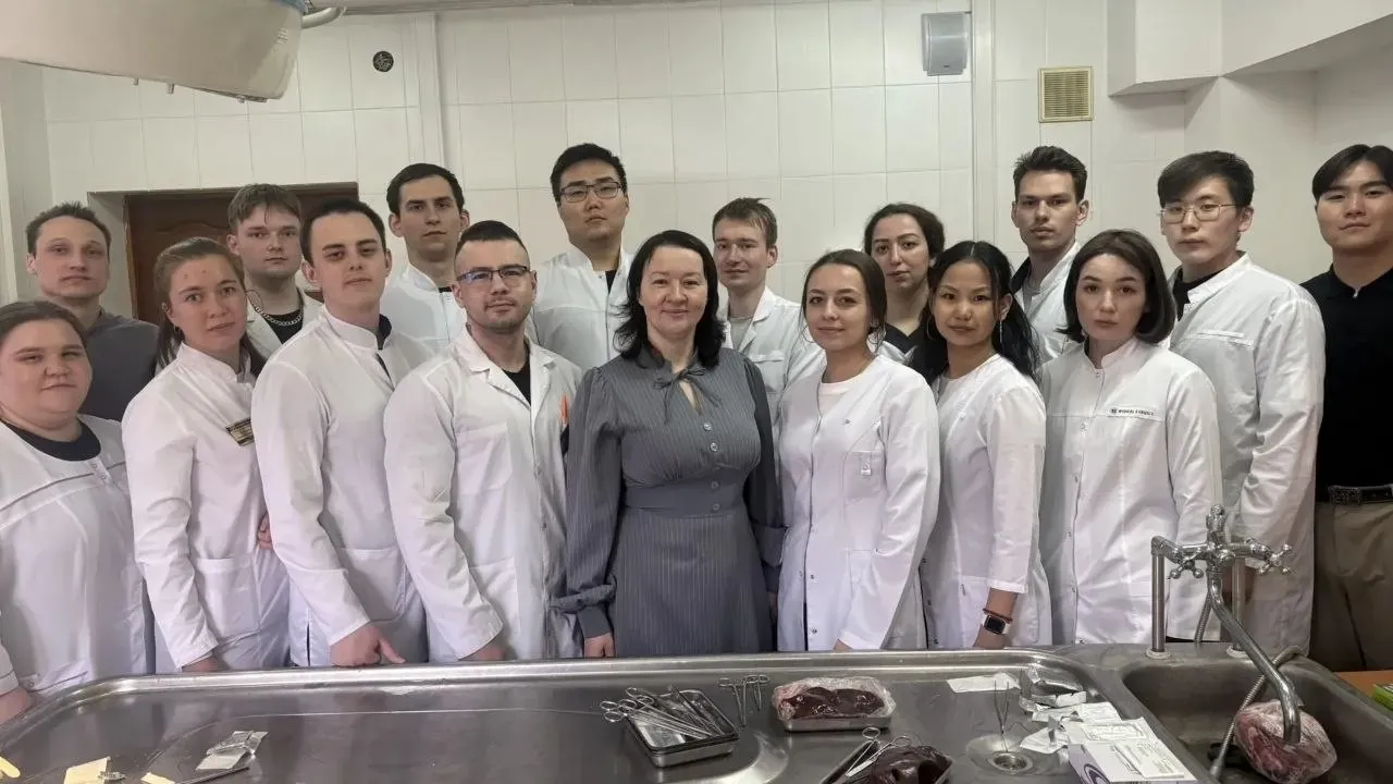 Medical students practicing surgical suturing techniques on biological material during master class